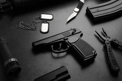 Photo of Composition with professional gun on black background