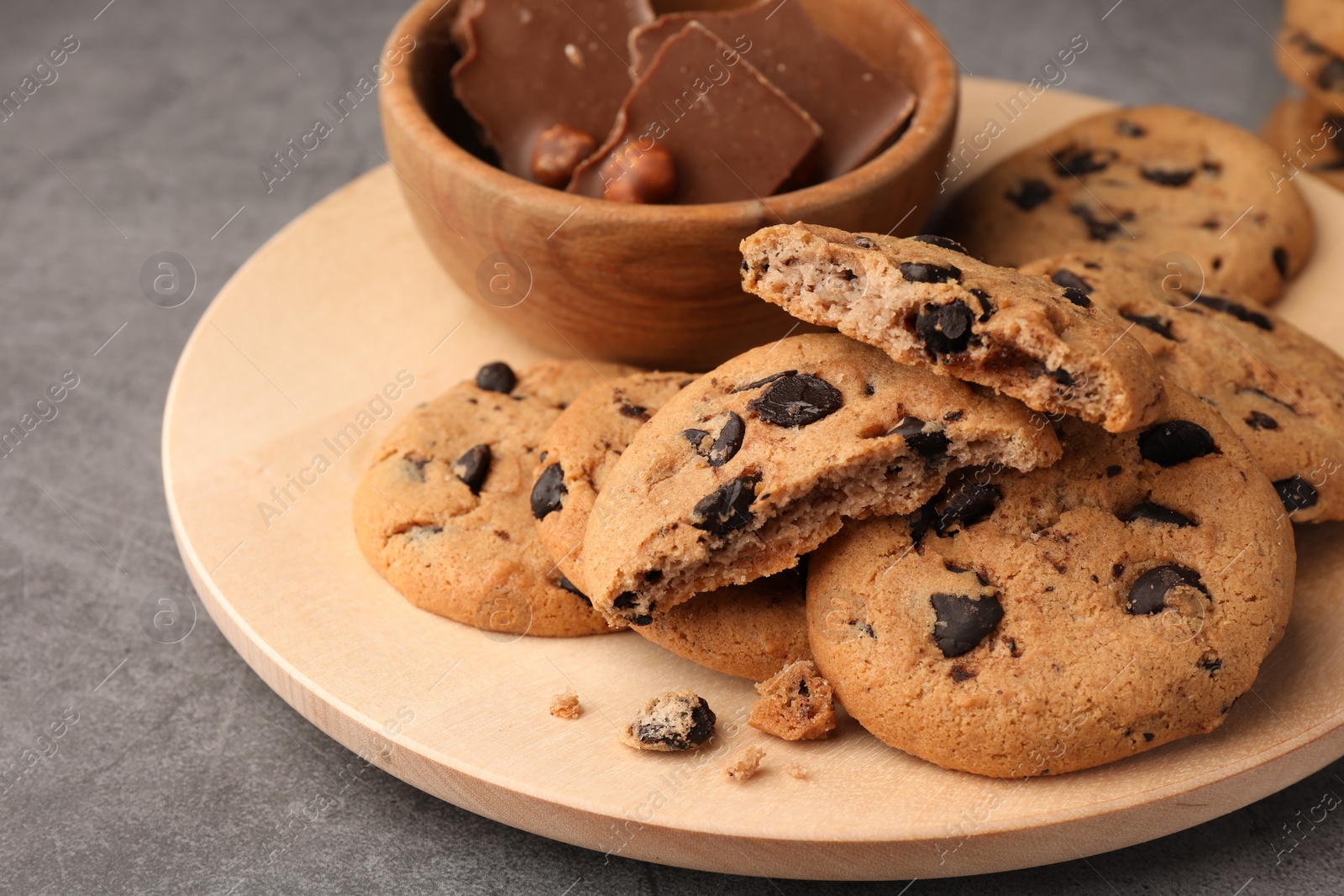 Photo of Delicious chocolate chip cookies on grey table, closeup