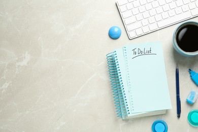 Flat lay composition with unfilled To Do list, cup of coffee and computer keyboard on light grey marble table, space for text