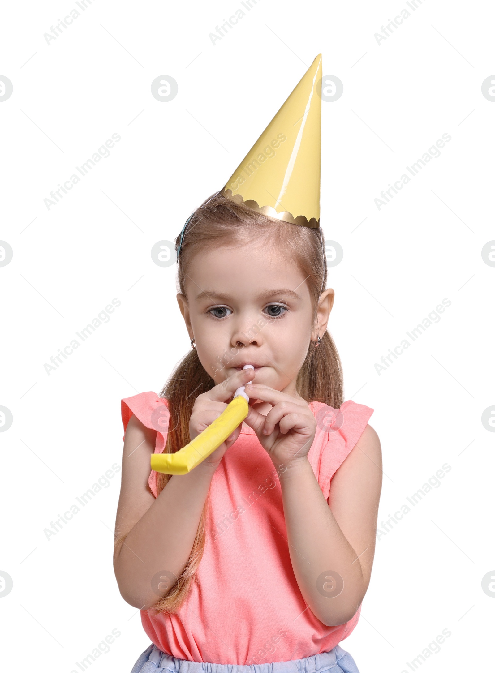 Photo of Birthday celebration. Cute little girl in party hat with blower on white background