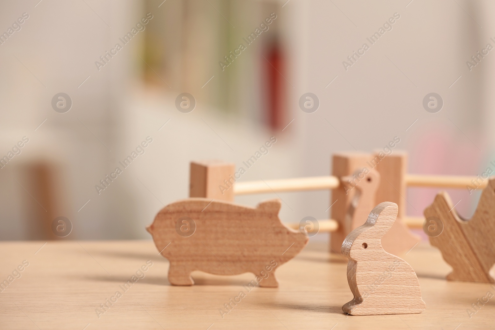 Photo of Wooden animals and fence on table, closeup. Space for text. Children's toys