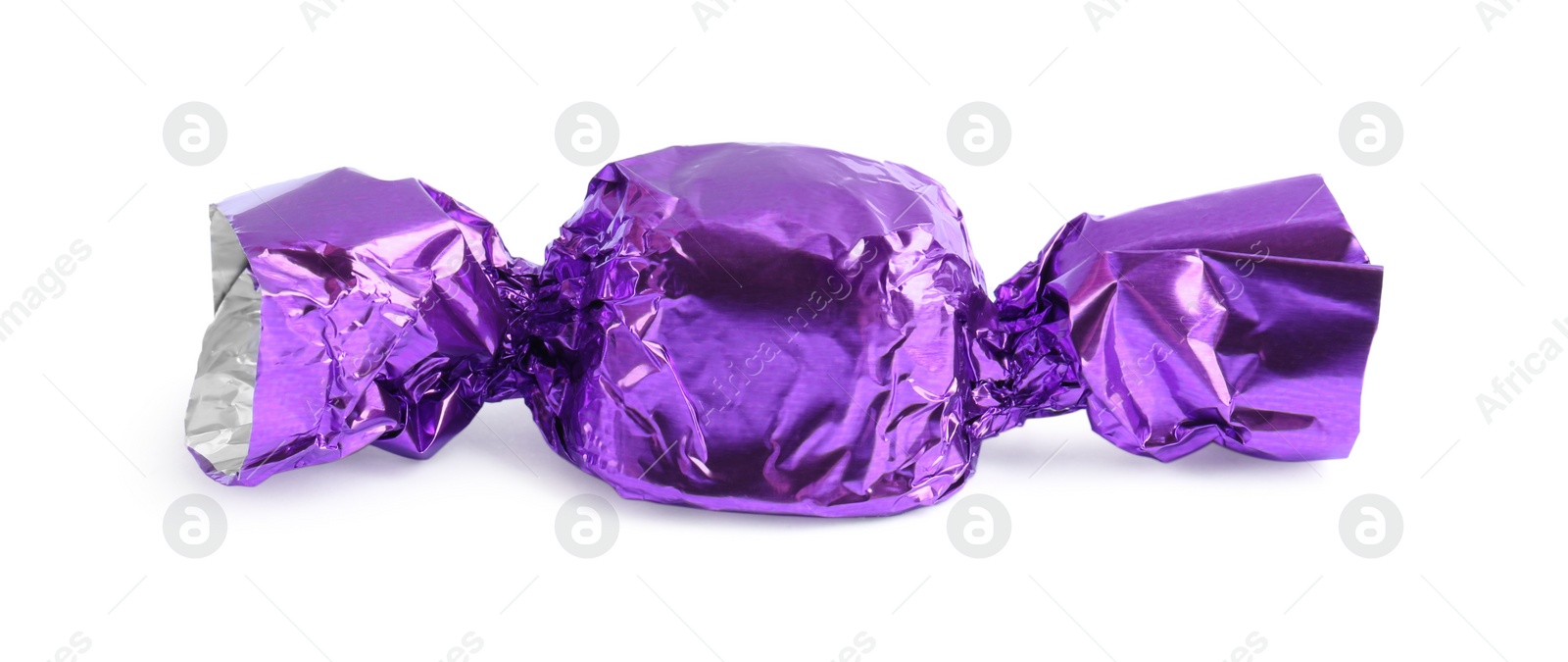 Photo of Tasty candy in purple wrapper isolated on white