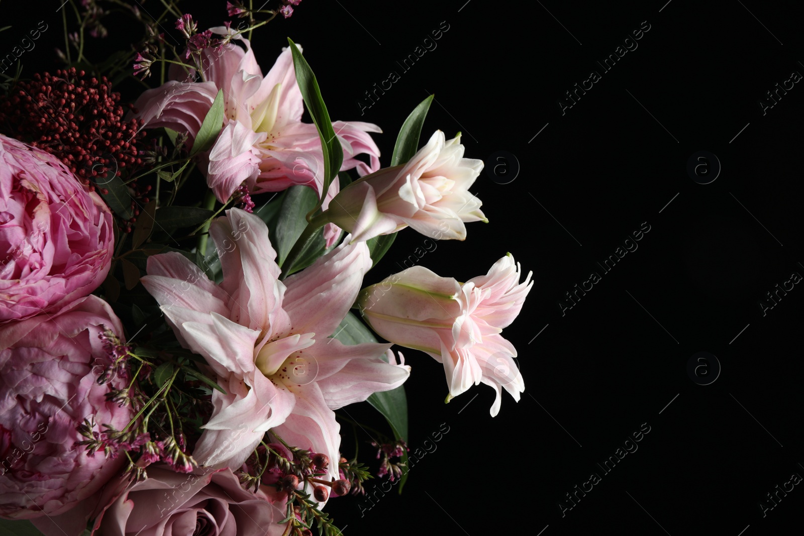 Photo of Beautiful bouquet of different flowers on dark background, closeup