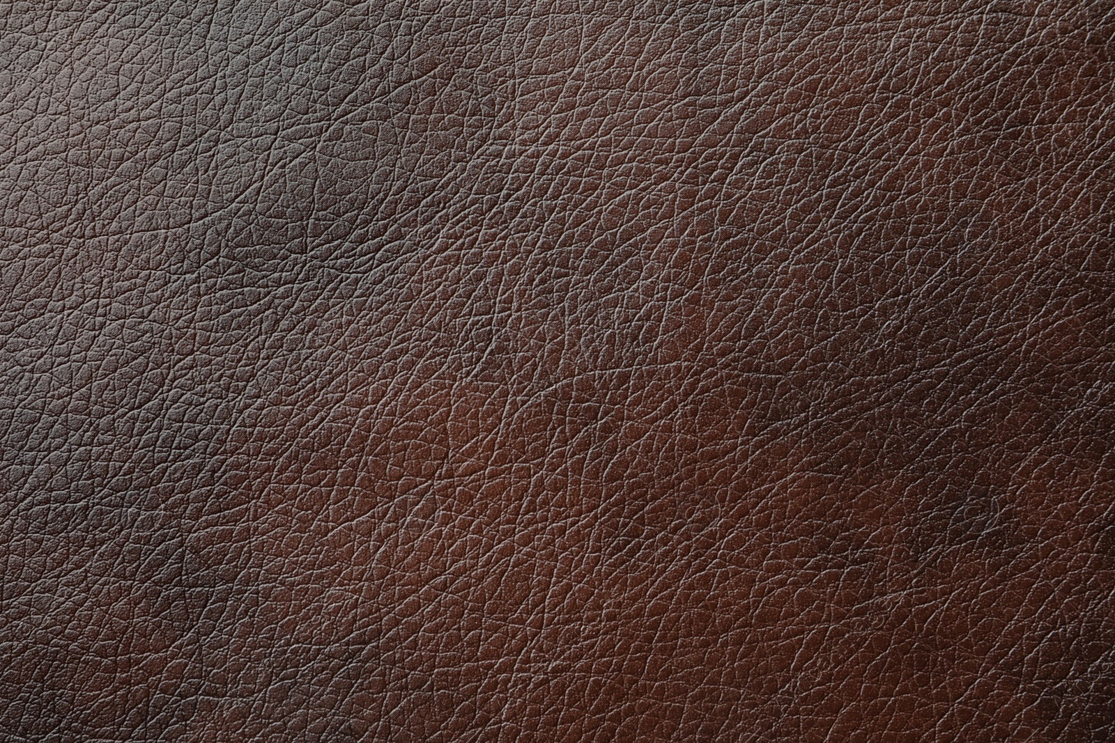 Photo of Texture of dark brown leather as background, closeup