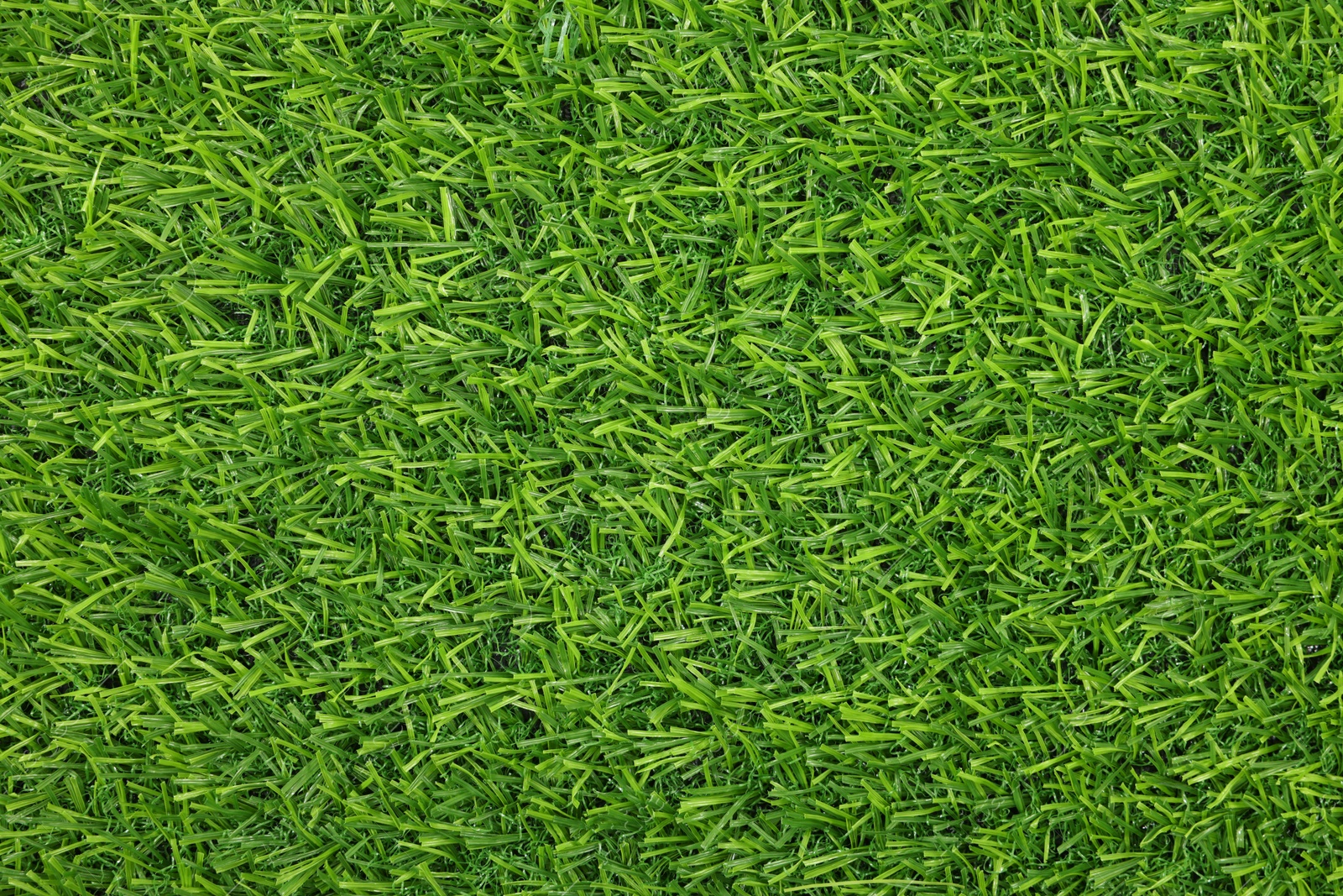 Photo of Green artificial grass as background, top view