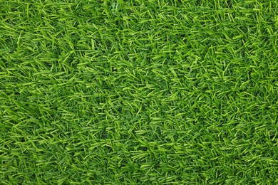 Photo of Green artificial grass as background, top view