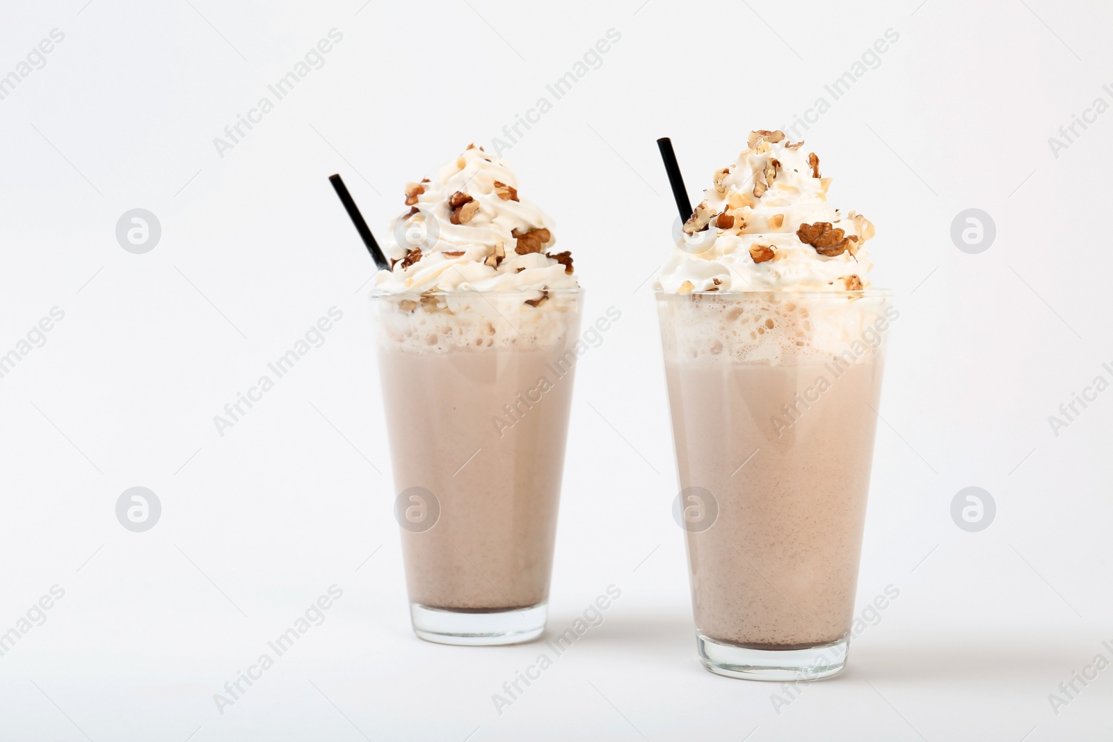 Photo of Glasses with delicious milk shakes on white background