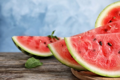 Fresh juicy watermelon slices on wooden table