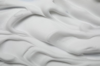 Texture of white shaving foam as background, closeup