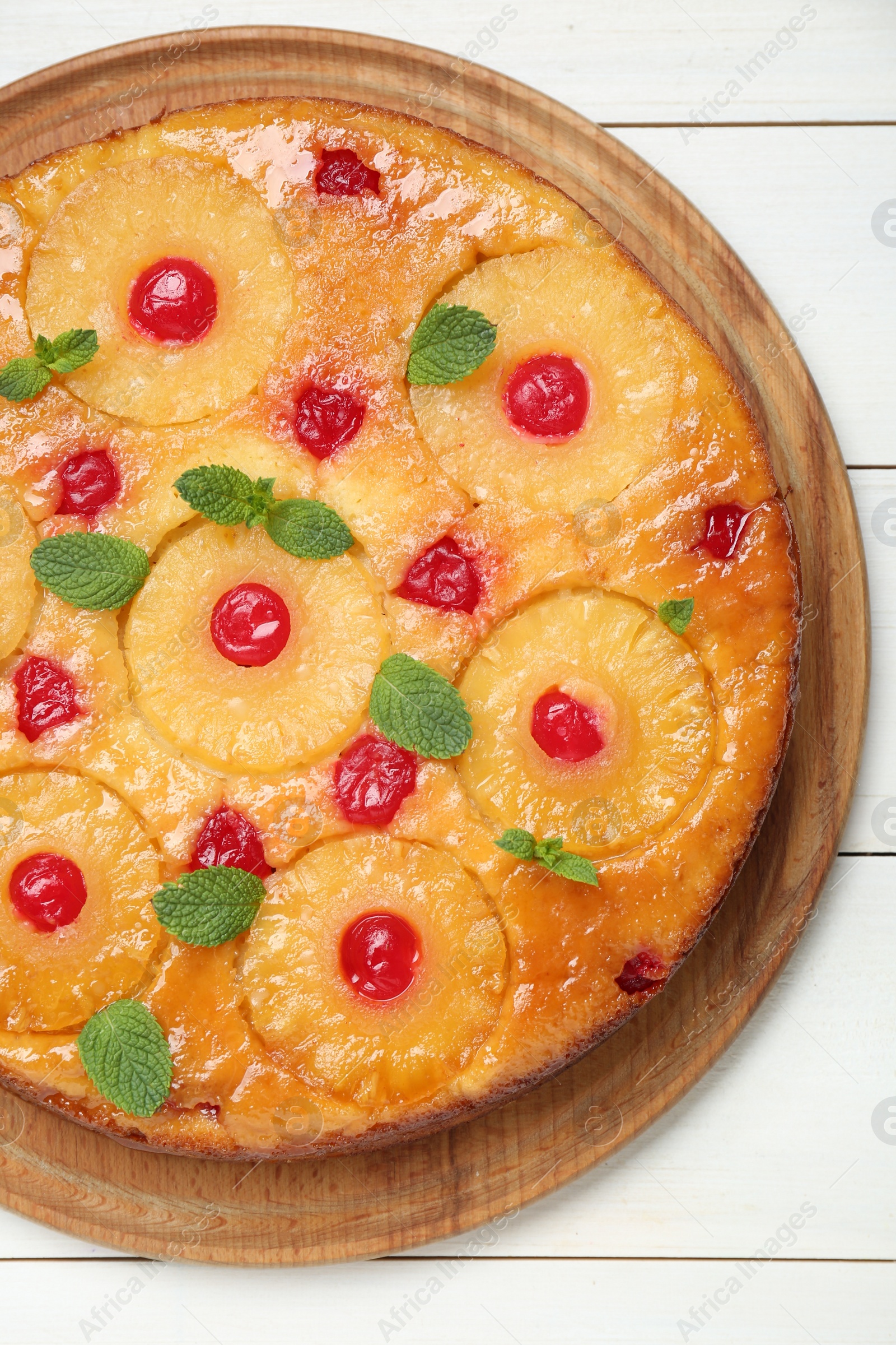 Photo of Delicious pineapple pie with cherry and mint on white wooden table, top view