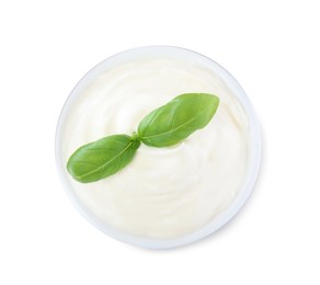 Photo of Delicious sour cream with basil in bowl on white background, top view