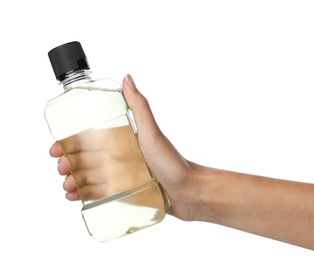 Woman holding bottle with mouthwash for teeth care on white background