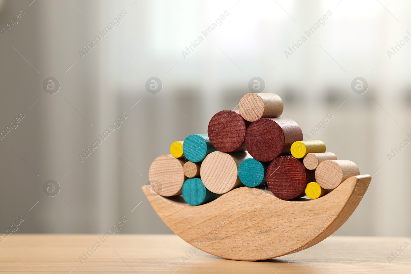 Photo of Wooden balance toy on table indoors, closeup. Space for text. Children's development