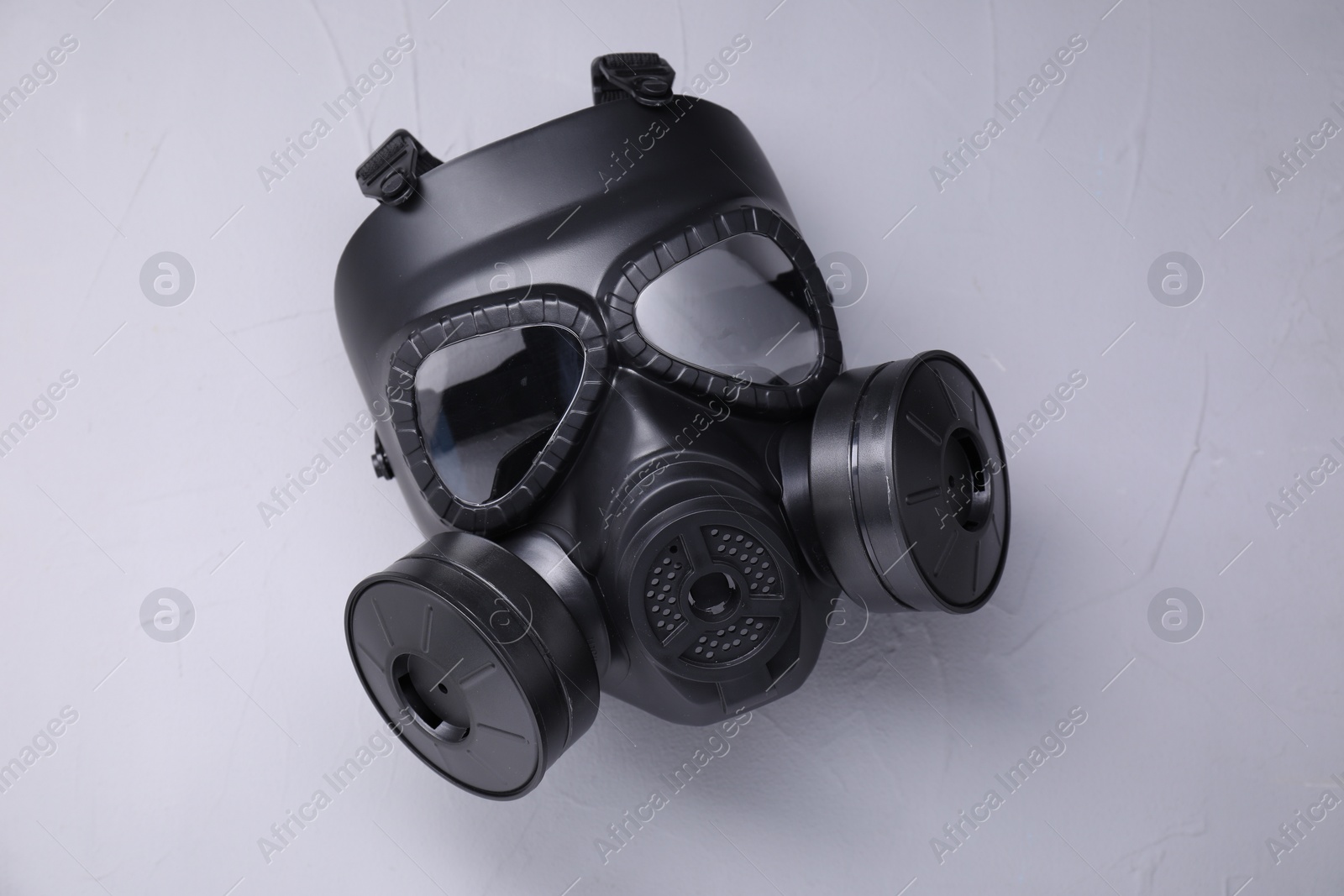 Photo of One gas mask on grey textured background, top view