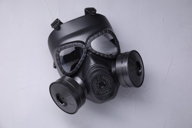 Photo of One gas mask on grey textured background, top view