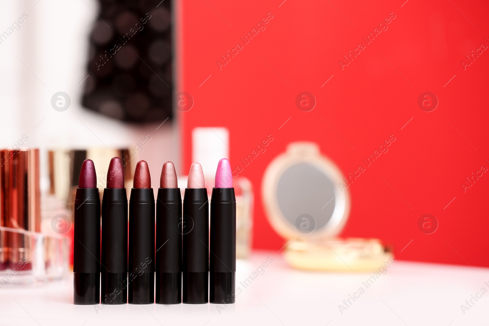 Photo of Different lipsticks on dressing table. Space for text