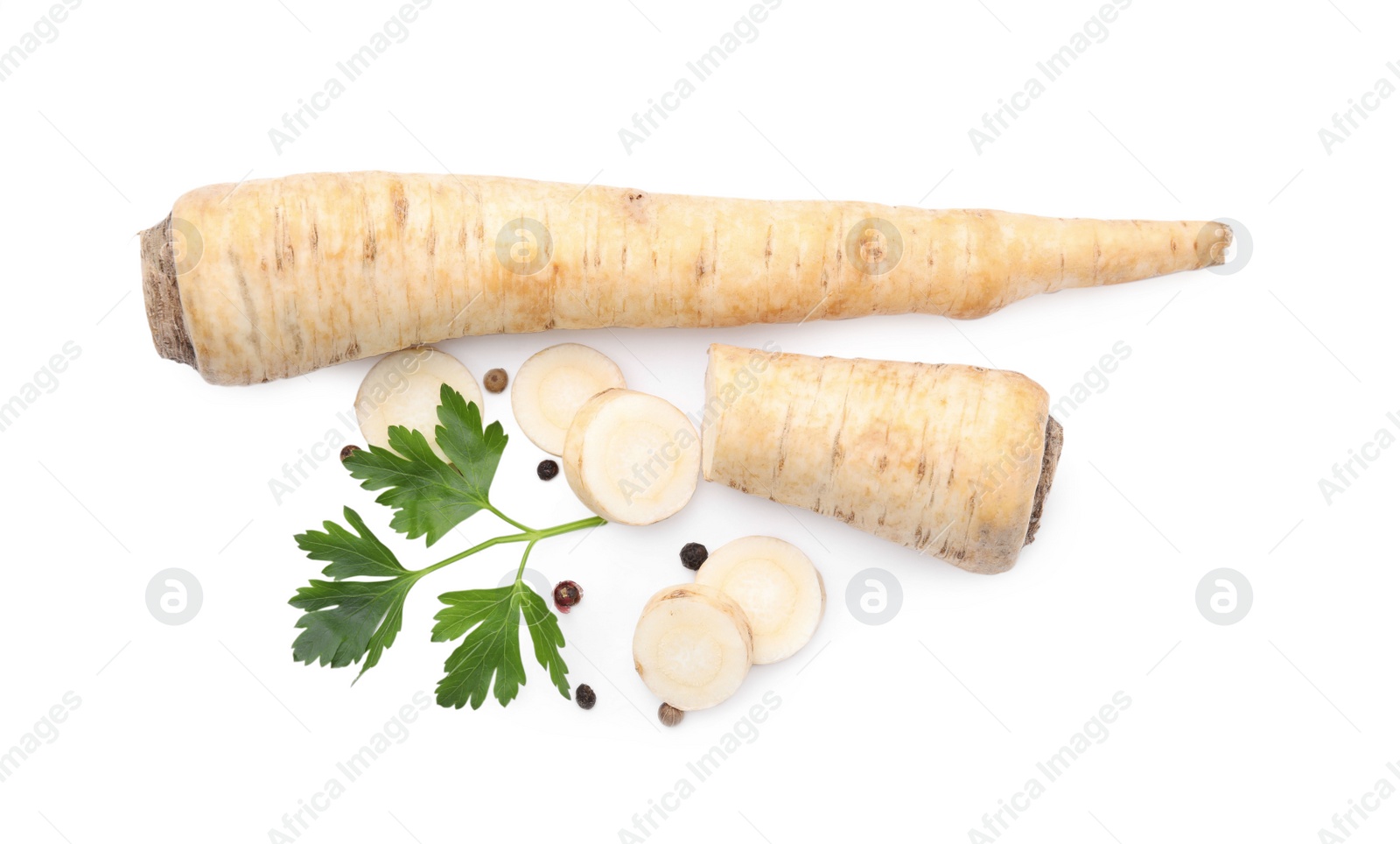 Photo of Whole and cut raw parsley root, fresh herb isolated on white, top view