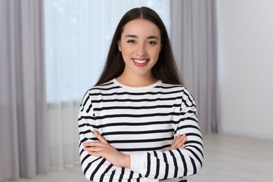 Portrait of beautiful young woman at home