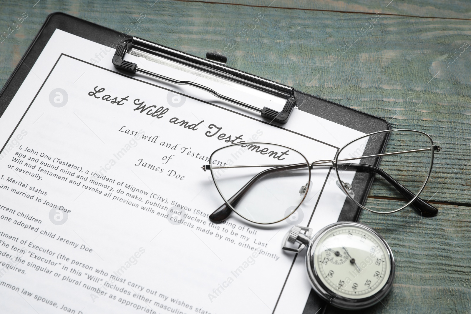 Photo of Last Will and Testament, pocket watch and glasses on rustic wooden table, closeup