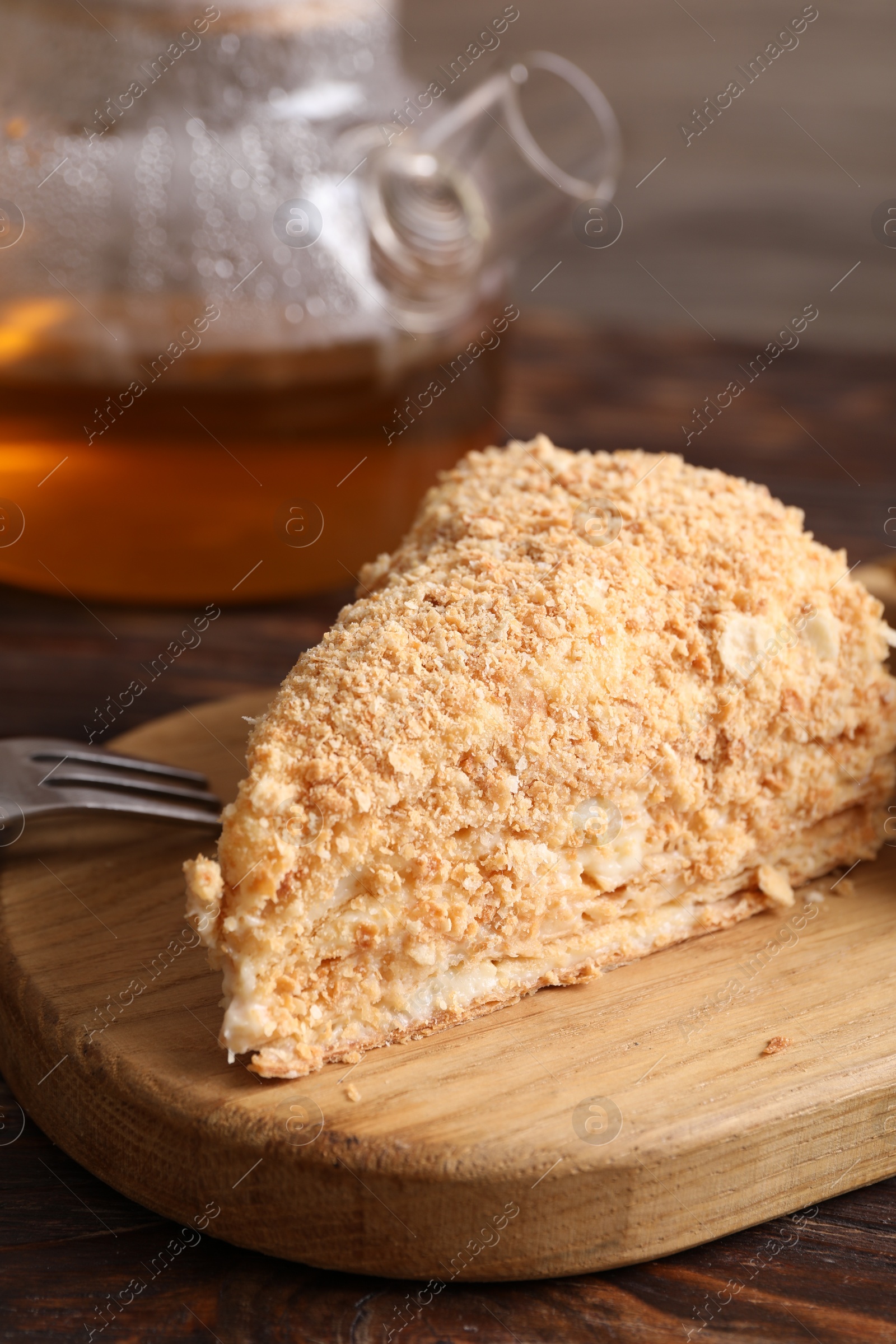 Photo of Piece of delicious Napoleon cake served on table, closeup