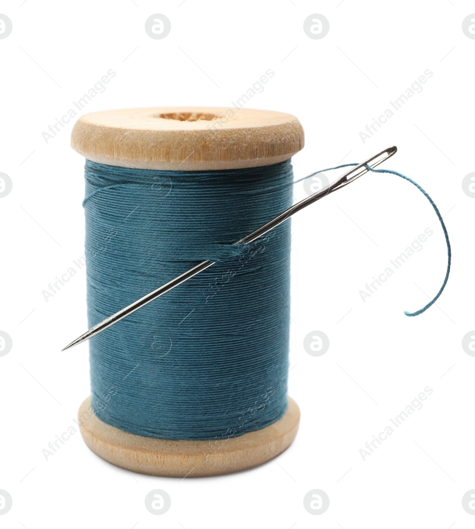 Photo of Light blue sewing thread with needle on white background