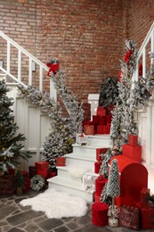 Christmas tree, gift boxes and festive decor indoors. Interior design