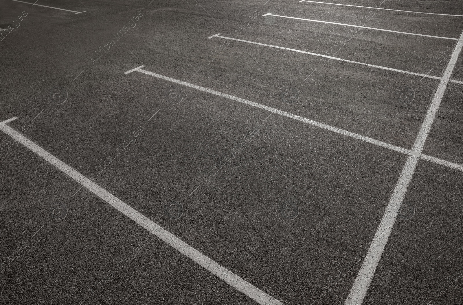 Photo of Outdoor car parking lot with white marking lines 