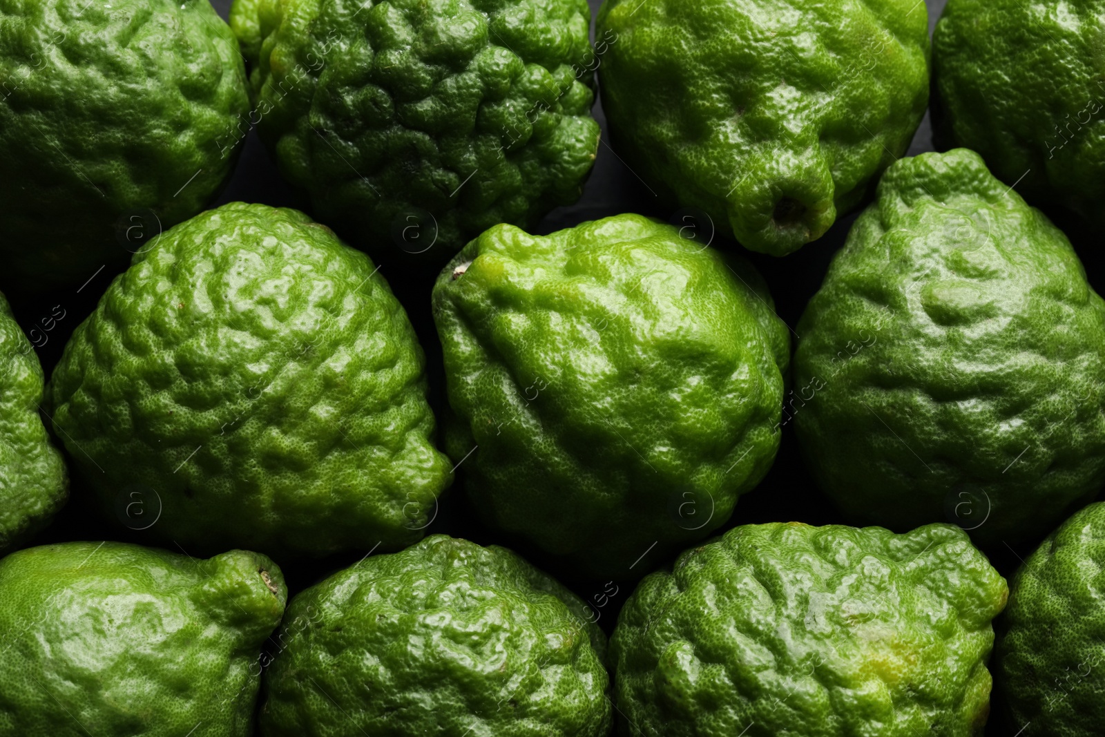 Photo of Fresh ripe bergamot fruits as background, top view