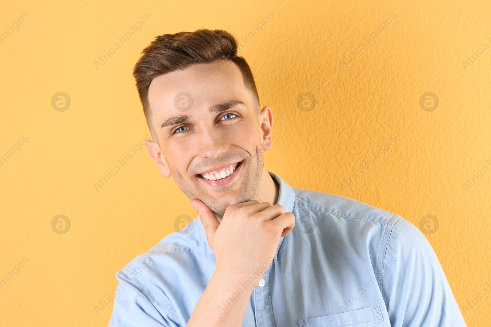 Photo of Portrait of young man with beautiful hair on color background