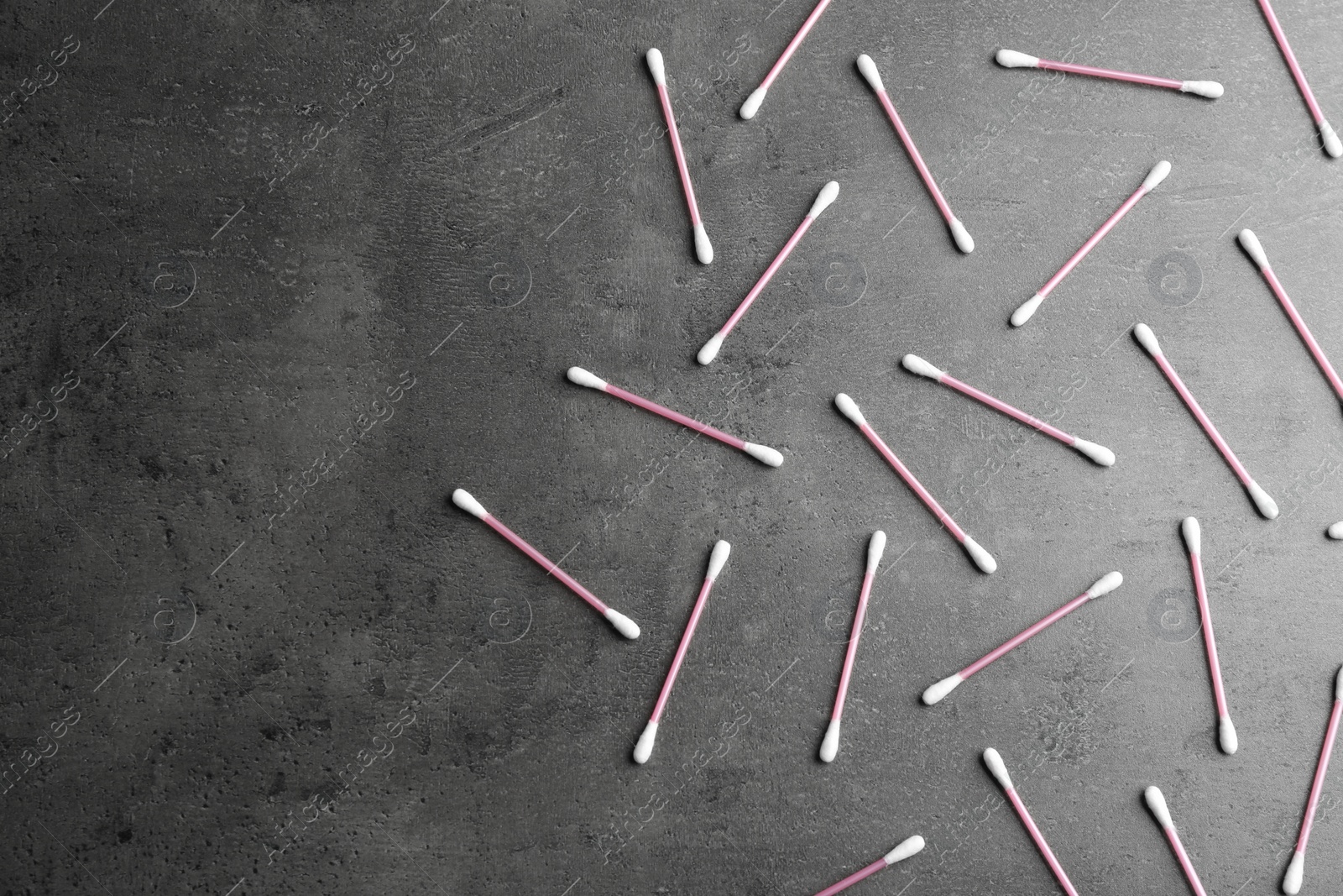 Photo of Flat lay composition with cotton swabs on grey background. Space for text