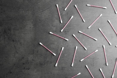 Photo of Flat lay composition with cotton swabs on grey background. Space for text