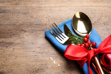 Cutlery set on wooden table, space for text. Christmas celebration