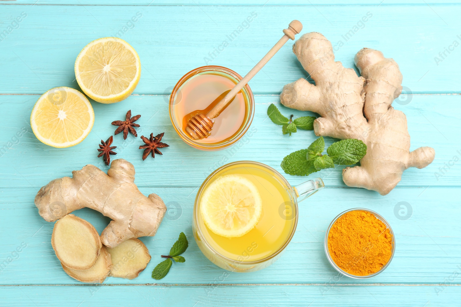 Photo of Flat lay composition with immunity boosting drink and ingredients on turquoise wooden table