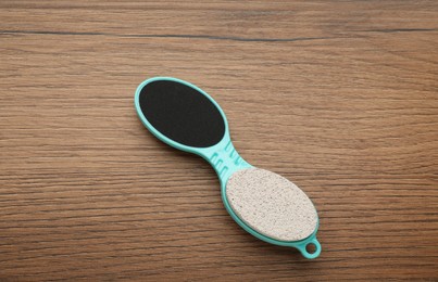 Pedicure tool with pumice stone and foot file on wooden table, top view