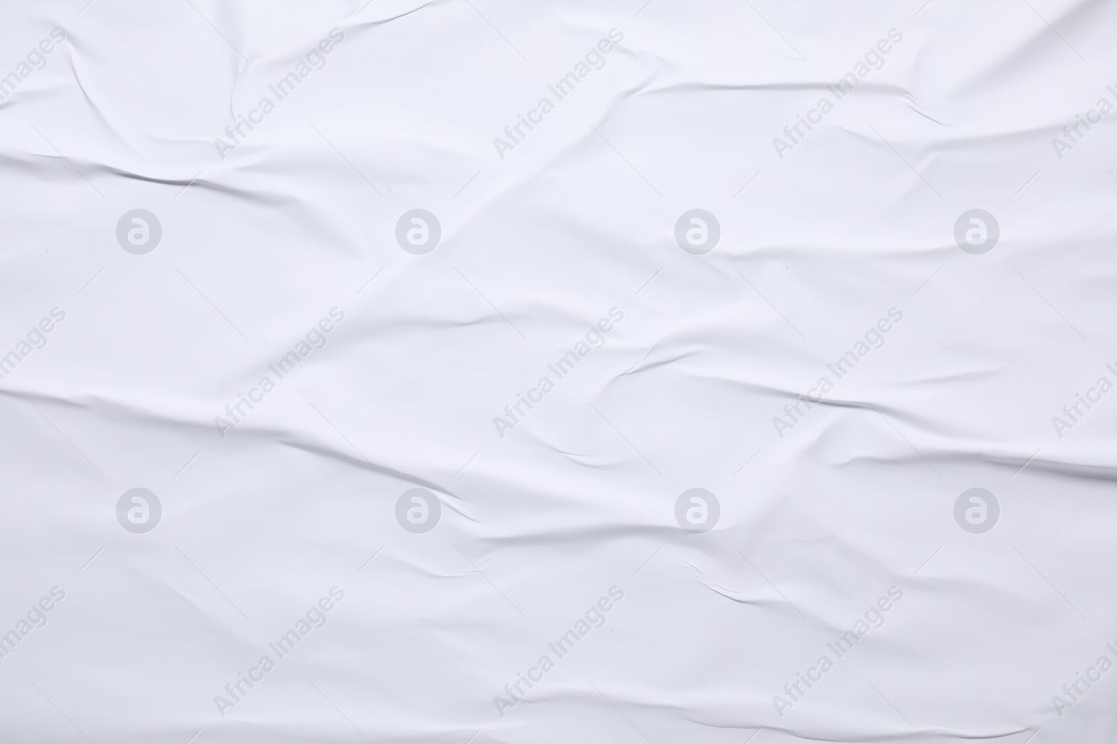 Photo of White crumpled sheet of paper as background, top view. Wall poster