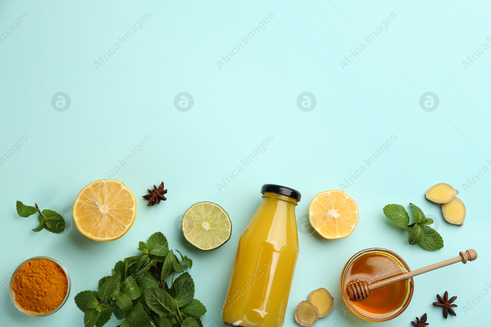 Photo of Flat lay composition with immunity boosting drink on light blue background. Space for text