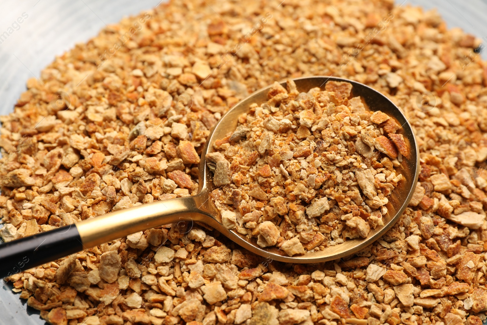 Photo of Dried orange seasoning zest on plate, closeup