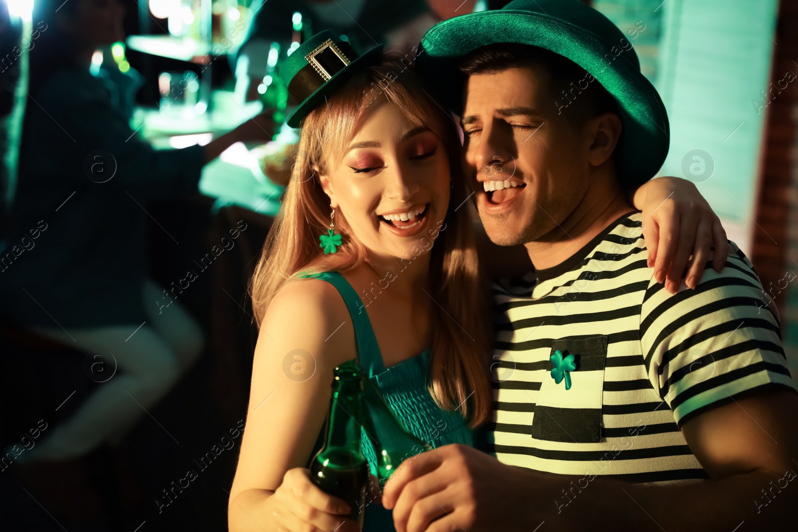 Photo of Couple with beer celebrating St Patrick's day in pub