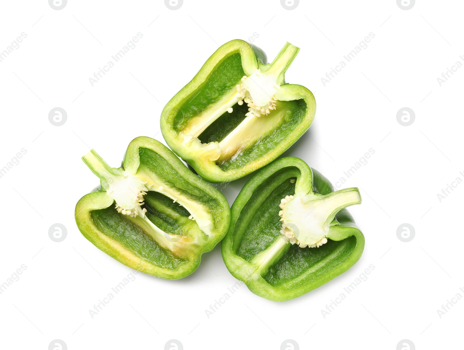 Photo of Halves of green bell peppers on white background, top view