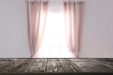 Empty wooden surface and blurred view of modern window 