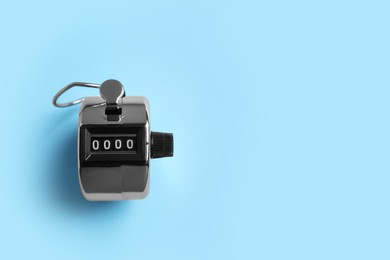 Photo of Modern timer on light blue background, top view. Space for text