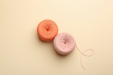 Clews of knitting threads on color background, flat lay. Sewing stuff