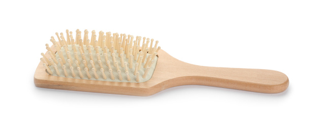 Photo of New wooden hair brush isolated on white