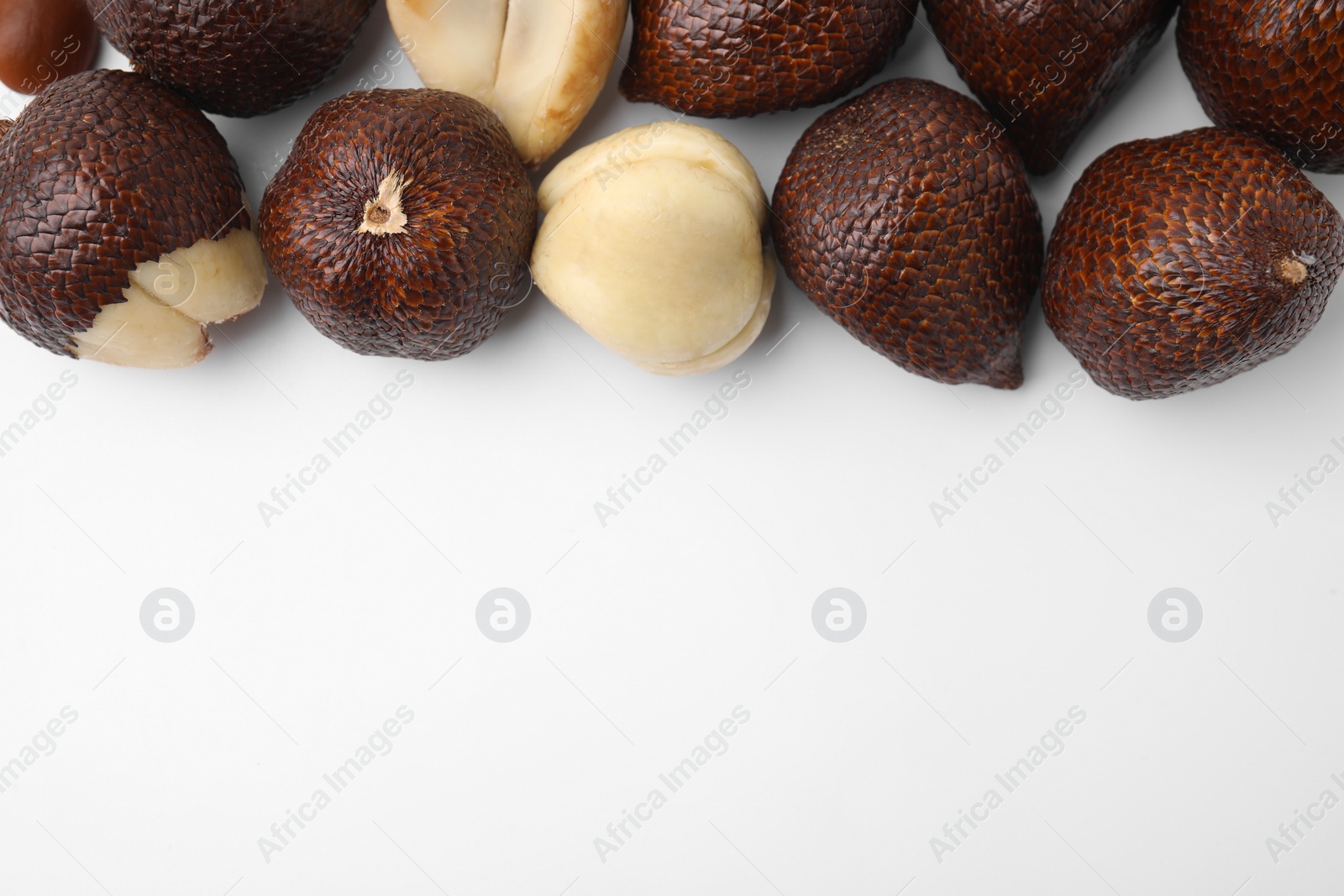 Photo of Fresh salak fruits on white background, flat lay. Space for text