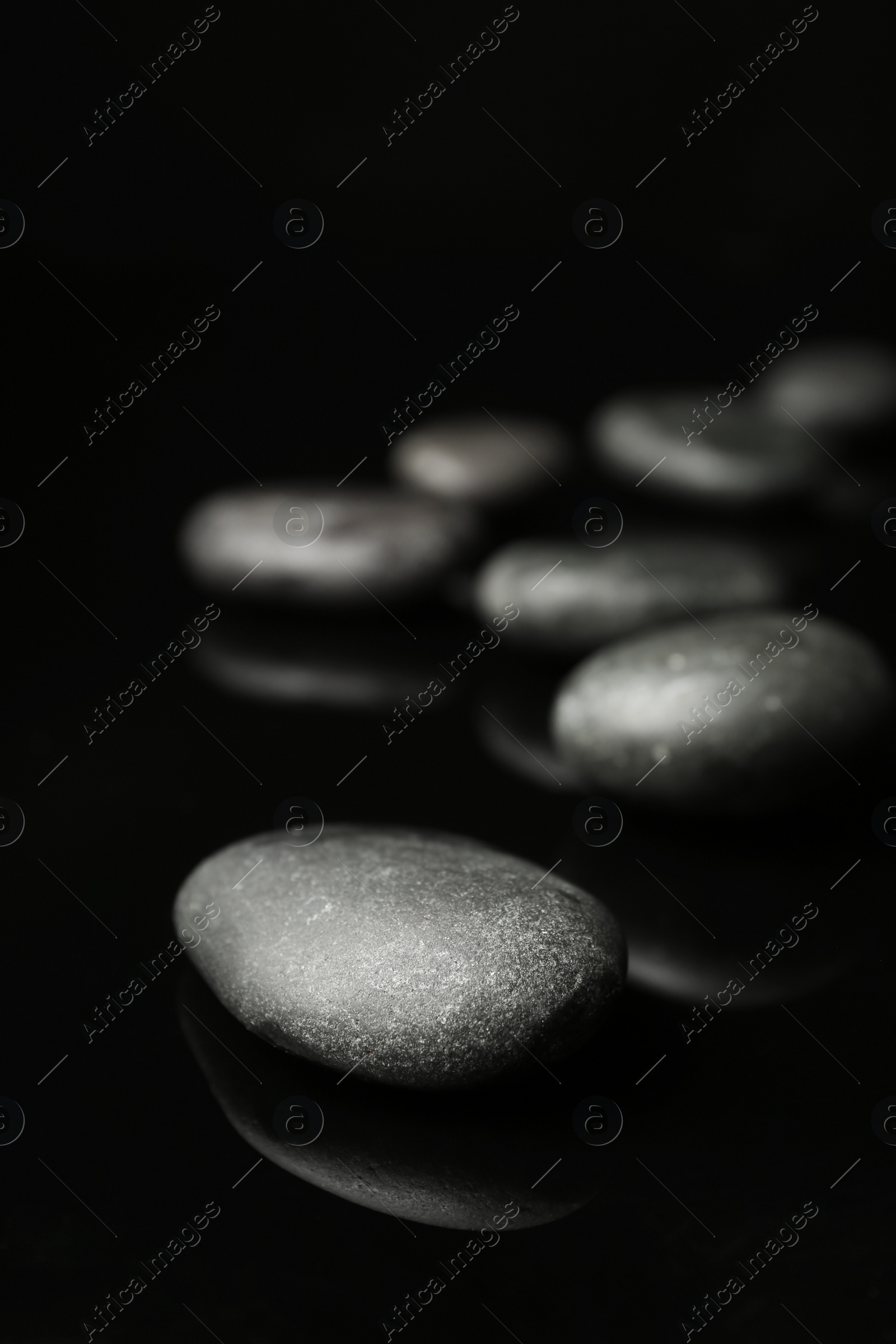 Photo of Spa stones on black background. Space for text