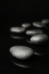 Spa stones on black background. Space for text