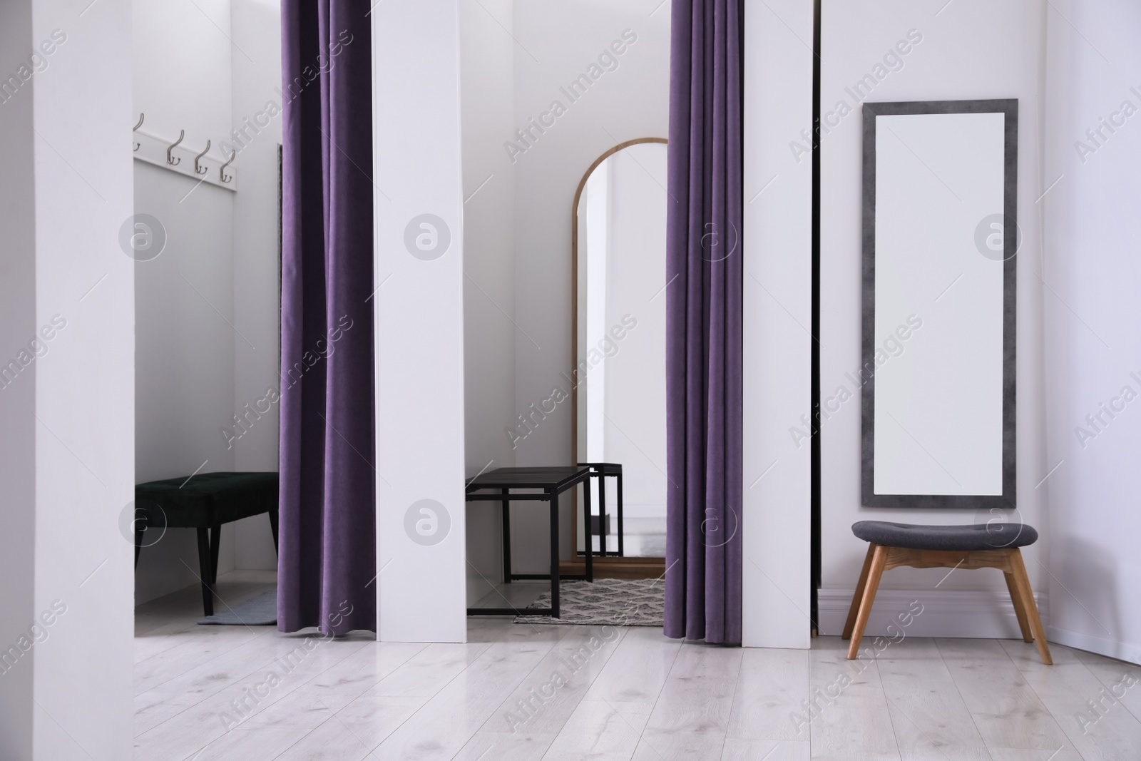 Photo of Empty dressing rooms in fashion store. Stylish interior