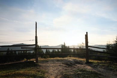 Wooden fence with barbed wire in morning