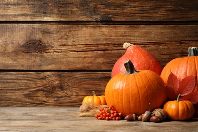Composition with ripe pumpkins on wooden table, space for text. Happy Thanksgiving day