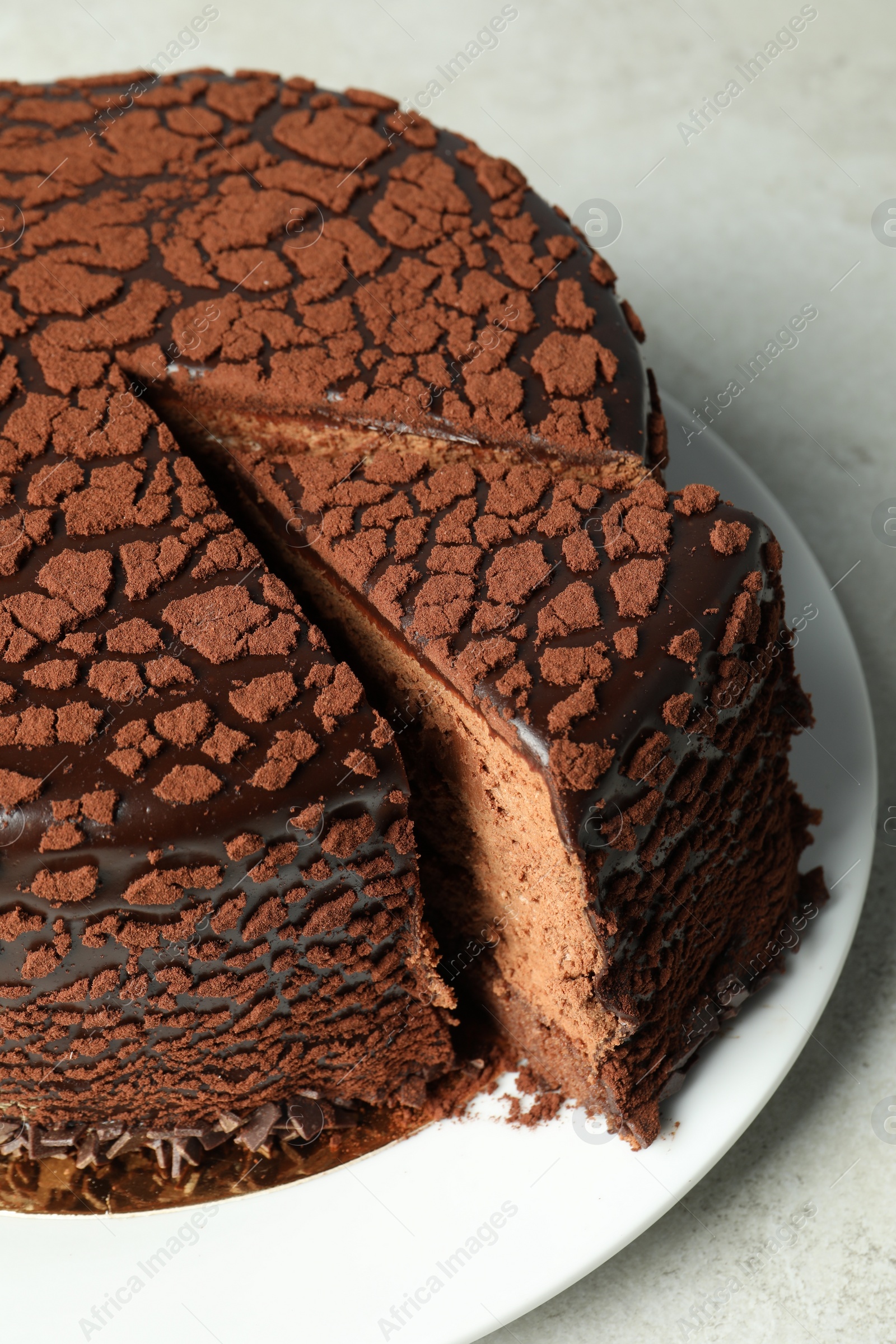 Photo of Delicious chocolate truffle cake on grey table